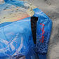 Angler 24-7 fishing shirt with logo on sand.